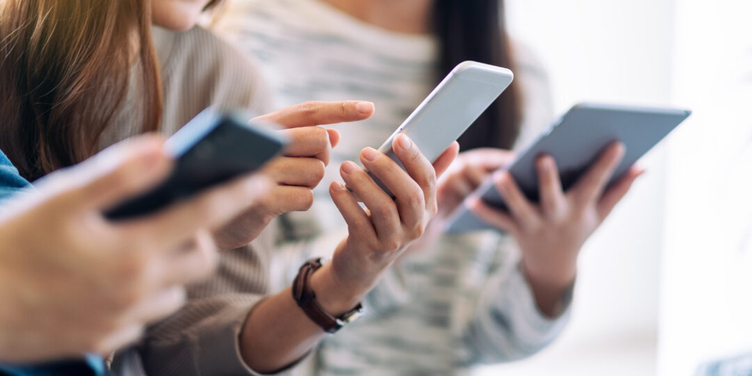 Group of people using and looking at mobile phone and tablet pc