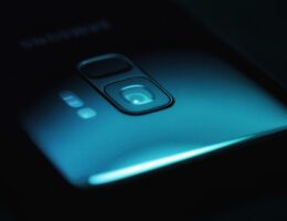 Die Rückseite eines Smartphones in dunkler Umgebung. Bild: Jonah Pettrich / Unsplash