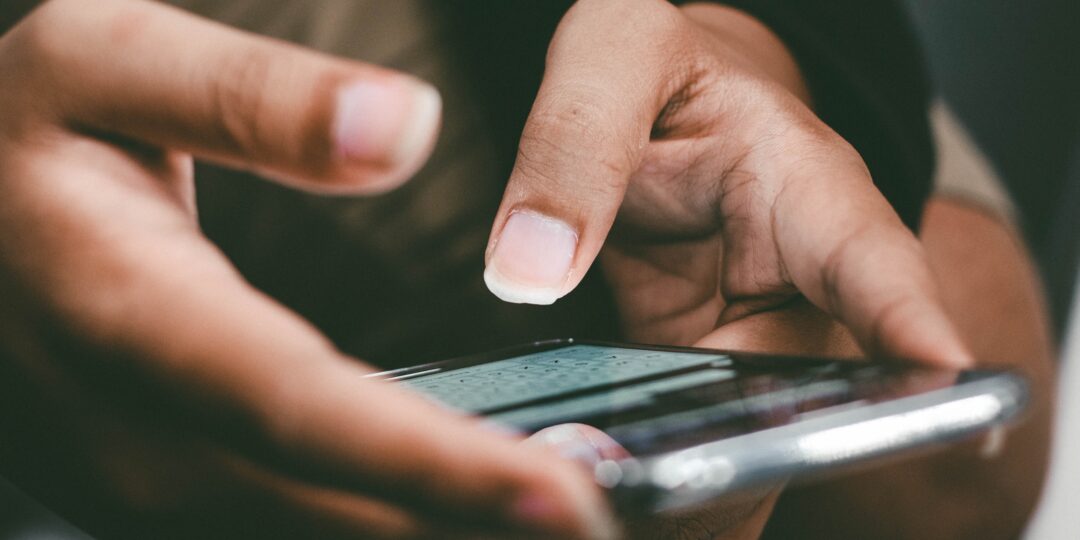 Eine Frau nutzt einen Messenger-Dienst auf ihrem Smartphone.